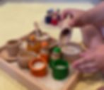 Child at play with LETme Toys sensory bin kit and peg people