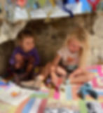 Children at play with LETme Toys on a quilt