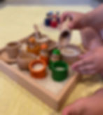 Child with LEtme Toys sensory bin kit and Peg People with cups and tray